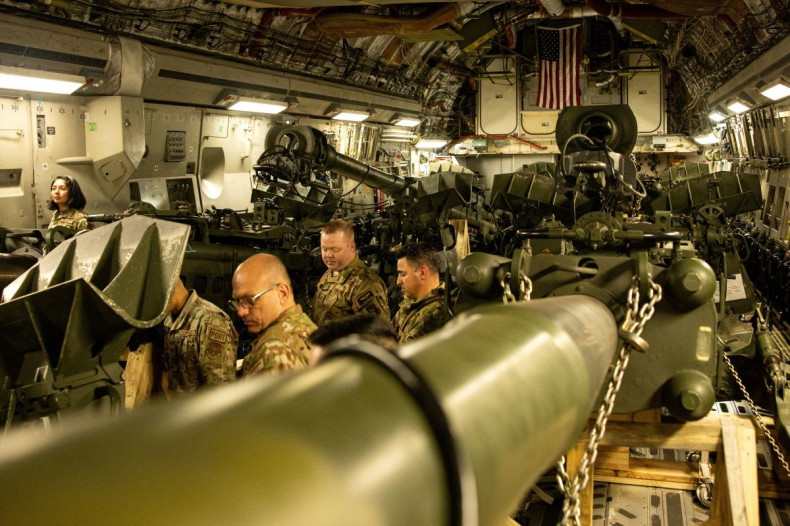 U.S. Marines load an M777 towed 155 mm howitzer into the cargo hold of a U.S. Air Force C-17 Globemaster III transport plane, to be delivered in Europe for Ukrainian forces, at March Air Reserve Base, California, U.S. April 21, 2022. Picture taken April 2