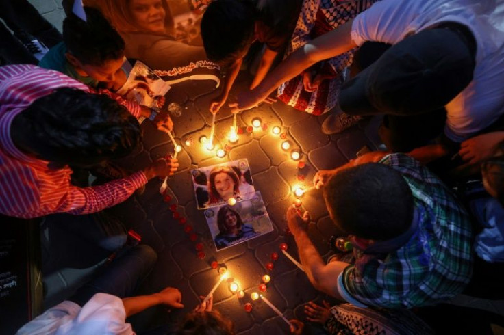 Palestinians light candles during a vigil in honour of Al-Jazeera journalist Shireen Abu Akleh in Gaza City on May 26, 2022