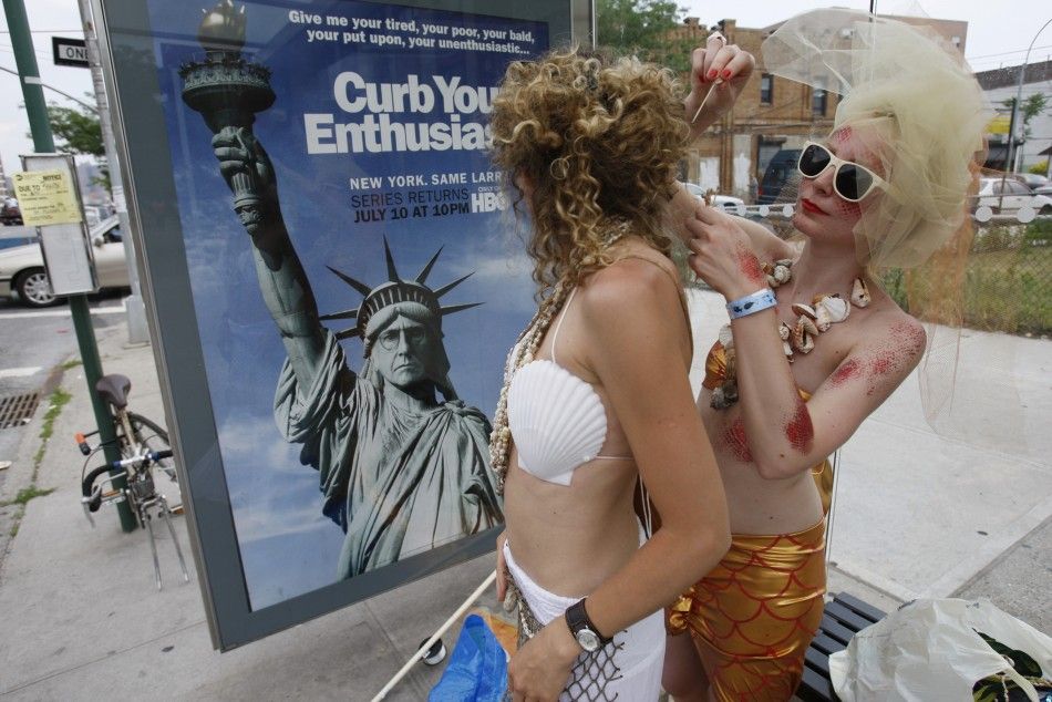 Anna Kolker fixes Karolina Formella039s hair at a bus stop before the start of the Mermaid Parade at Coney Island in the Brooklyn section of New York
