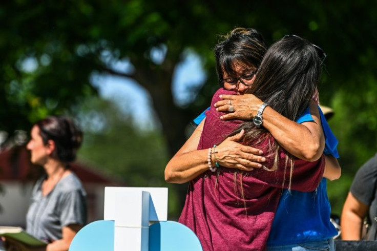 Dora Mendoza (R), the grandmother of Amerie Garza, who died in the mass shooting, mourns at a makeshift memorial outside Uvalde County Courthouse in Texas on May 26, 2022