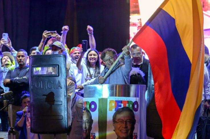 Left-wing presidential candidate Gustavo Petro waves a Colombian flag at a campaign rally in Bogota on May 22, 2022