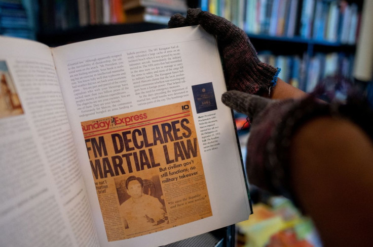 A bookstore owner shows a page of a book containing a newspaper clipping of the declaration of martial law, in Manila, Philippines, May 19, 2022. Picture taken May 19, 2022. 