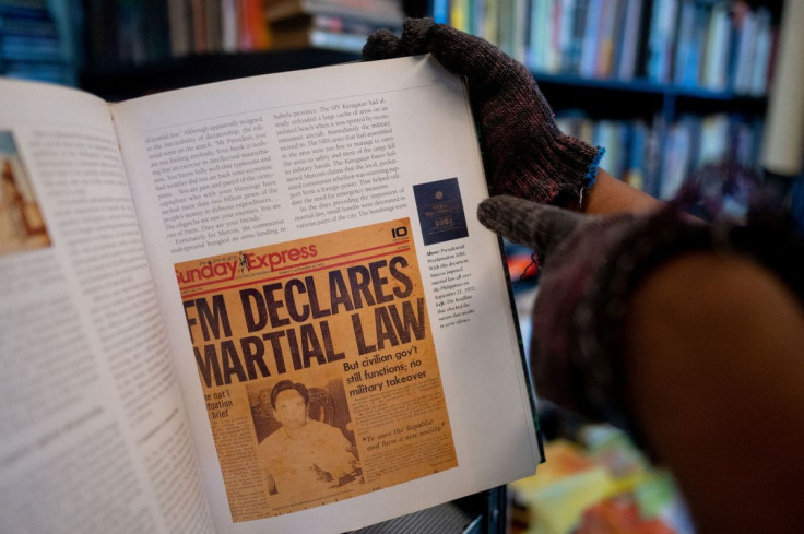 A bookstore owner shows a page of a book containing a newspaper clipping of the declaration of martial law, in Manila, Philippines, May 19, 2022. Picture taken May 19, 2022.