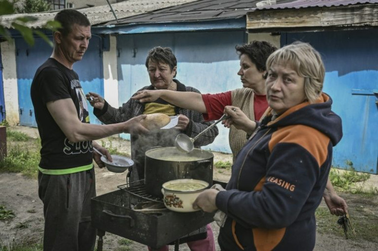 Residents of Ukraine's frontline cities brave shellfire while cooking outdoors over open flames due to damaged power and gas lines