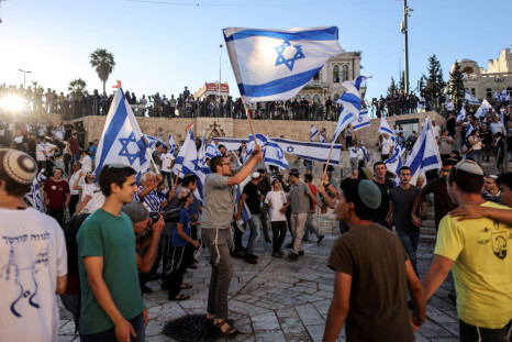 Israelis dance with flags by Damascus gate just outside Jerusalem's Old City June 15, 2021. 