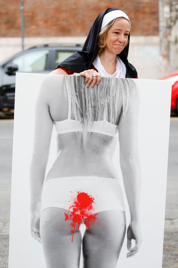 Federica Tourn, member of a sexual abuse victim group, participates in a flash mob outside the Vatican embassy to Italy, calling for an investigation into sexual abuse in the Italian Catholic Church, in Rome, Italy, May 27, 2022. 