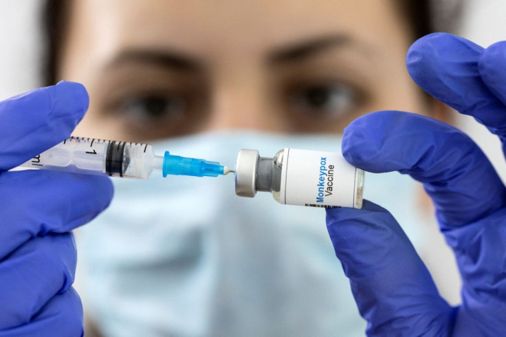 A woman holds a mock-up vial labeled "Monkeypox vaccine" and medical syringe in this illustration taken, May 25, 2022. 