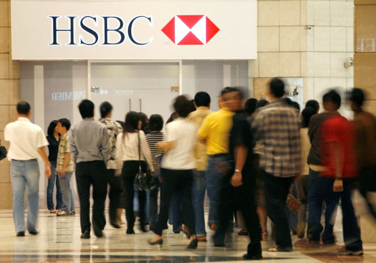 People walk in front of the headquarters for HSBC Bank in Jakarta April 11, 2008. 