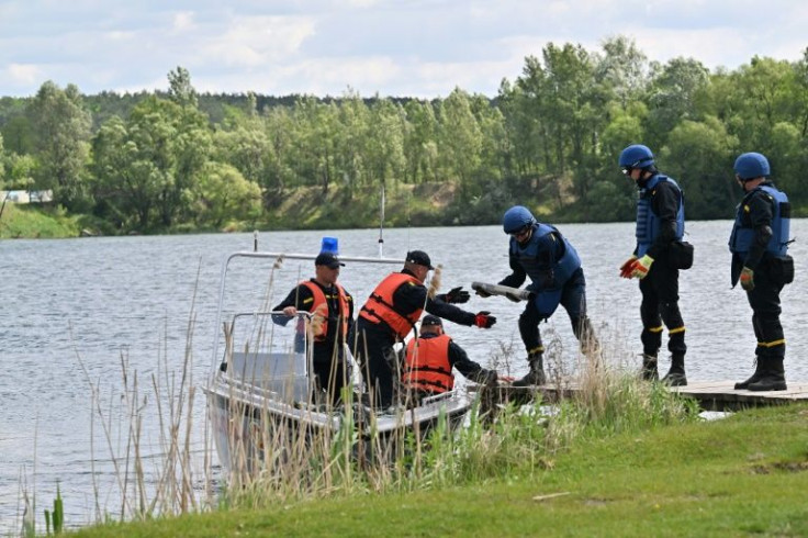 The unexploded projectiles are gingerly carried to trucks and transported to an uninhabited area