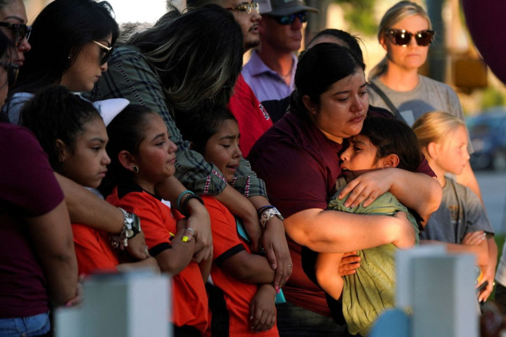People mourn the victims of the mass shooting at Robb Elementary School, in front of the Uvalde County Courthouse, Texas, U.S. May 26, 2022. Picture taken May 26, 2022. 