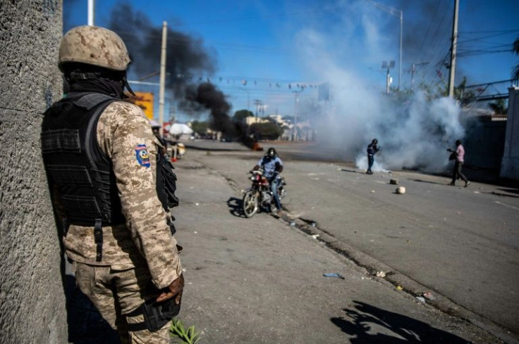 Police fire tear gas at factory workers demanding a pay rise in Port-au-Prince, Haiti, in February 2022