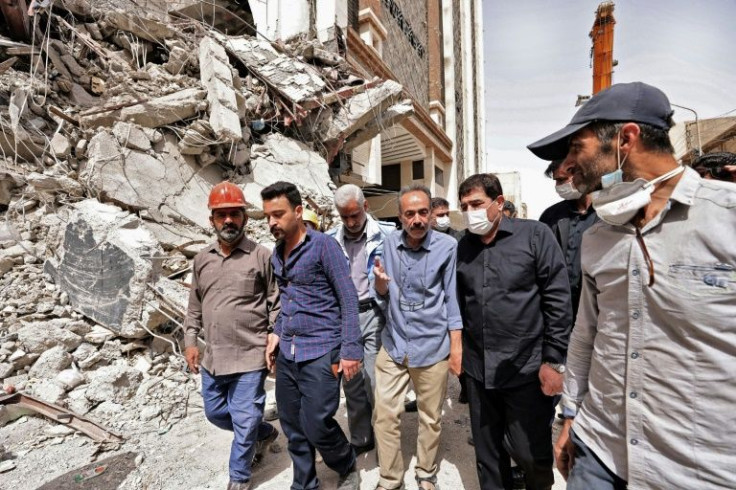 Iranian Vice President Mohammad Mokhber (2nd-R), shown visiting the site of the collapsed building, said there had been "widespread corruption"