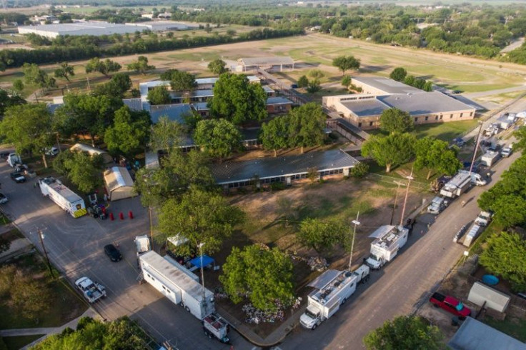An aerial view shows Robb Elementary School and the makeshift memorial (center, Bottom) for the shooting victims in Uvalde, Texas, on May 28, 2022