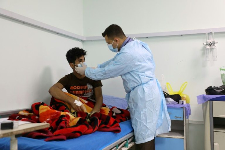 A doctor examines a patient infected with the tick-borne virus in Iraq's southern Dhi Qar province