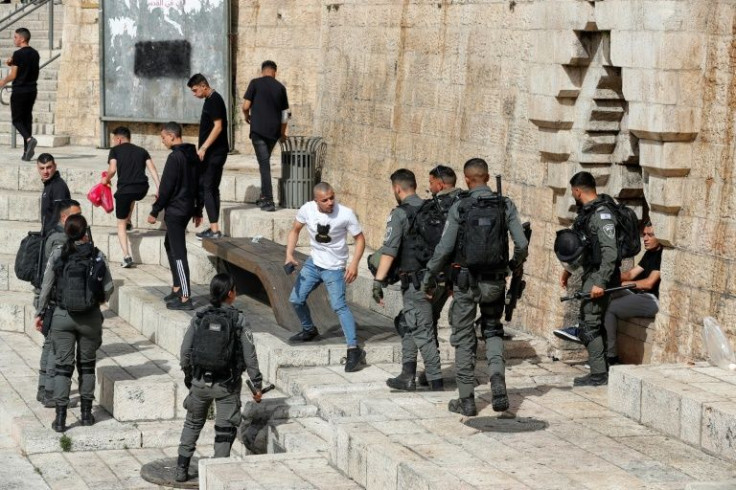 Members of Israeli security clear people away from Jerusalem's Damascus Gate, heavily used by Palestinians, and through which some of the Jewish marchers were expected to pass