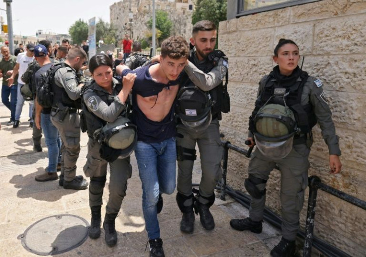 Members of Israeli security detain a Palestinian protester at Jerusalem's Damascus Gate