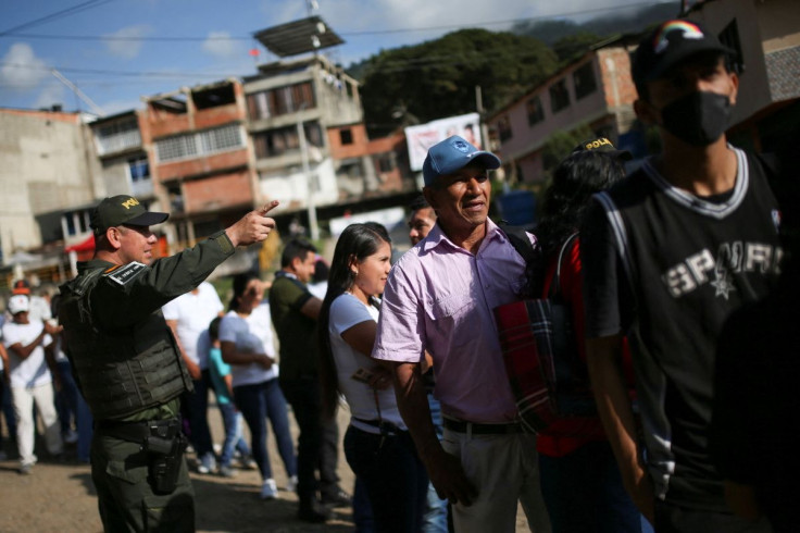 People line up to cast their ballots at a polling station during the first round of the presidential election in Suarez, Colombia May 29, 2022. 