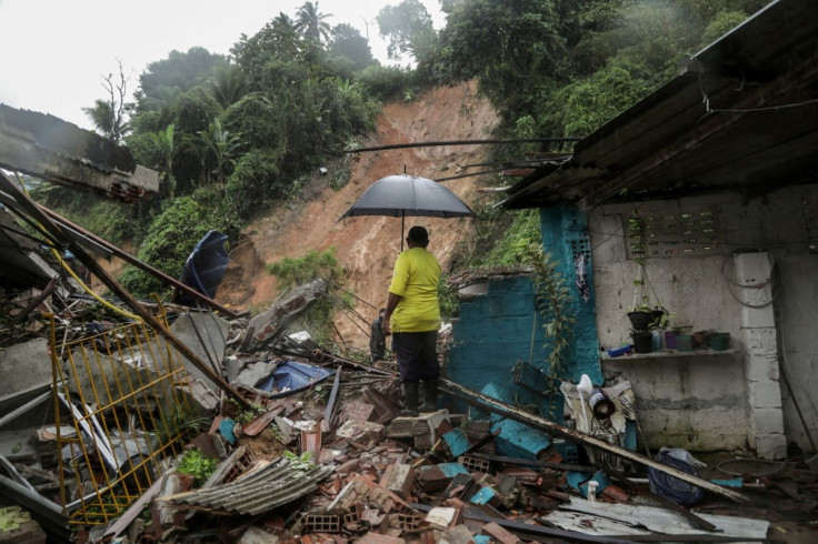 A man stands on the wreckage of a house collapsed during a landslide caused by heavy rains at Jardim Monte Verde, in Ibura neighbourhood, in Recife, Brazil, May 28, 2022. Diego Nigro/Prefeitura do Recife/Handout via REUTERS