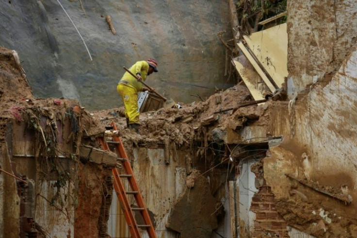 A man removes debris from a landslide area in the Jardim Monte Verde community in Recife, Brazil on May 29, 2022