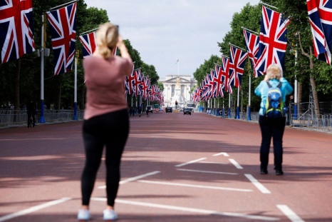 People take photographs of Buckingham Palace and The Mall ahead of the Platinum Jubilee celebrations for Britain's Queen Elizabeth in London, Britain, May 27, 2022. 