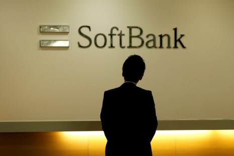 A man looks at the logo of SoftBank Group Corp at the company's headquarters in Tokyo, June 30, 2016.   