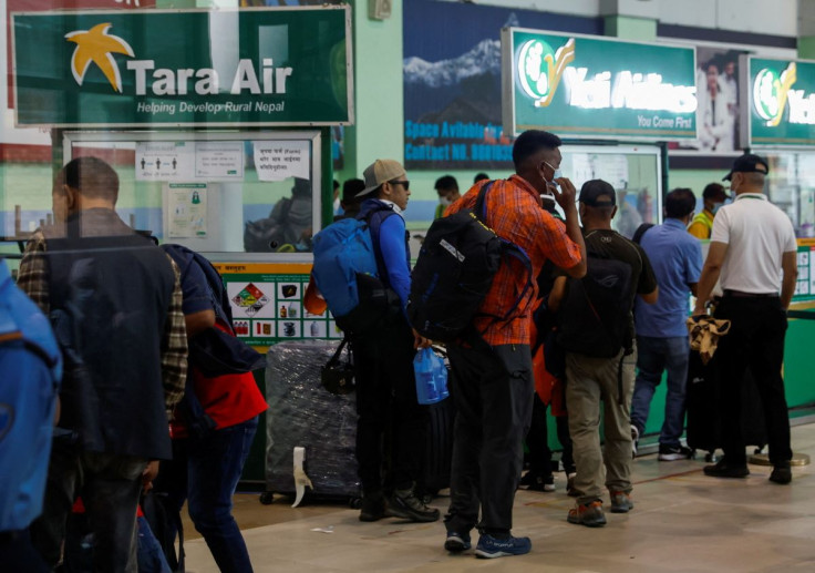 A group of mountaineers wait to board a flight as they head to search and rescue of a plane operated by Tara Air that went missing on Sunday with 22 people on board, while on its way to Jomsom, in Kathmandu, Nepal May 29, 2022. 