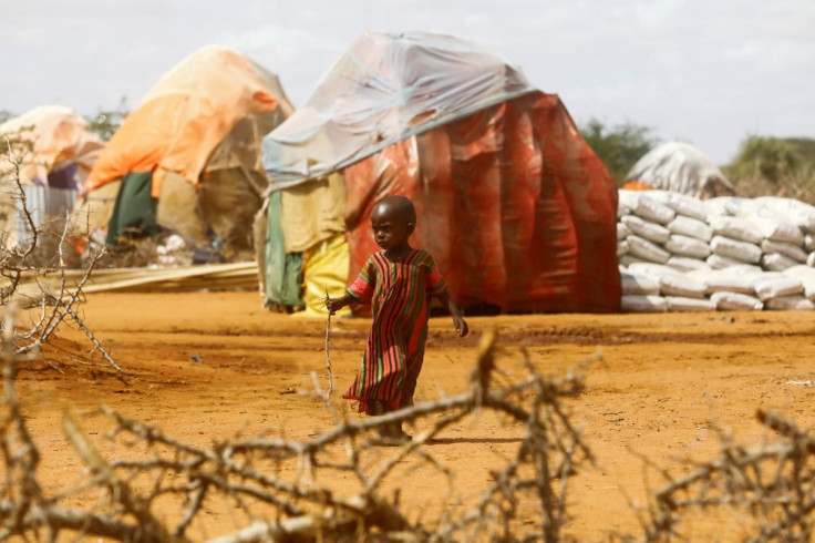 A child walks outside makeshift shelters at the Kaxareey camp for the internally displaced people after they fled from the severe droughts, in Dollow, Gedo Region, Somalia May 24, 2022. Picture taken May 24, 2022.