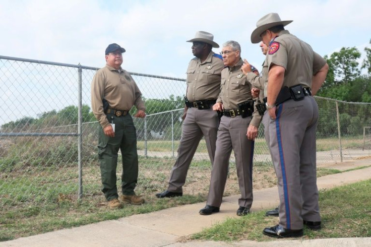 Steven McCraw, director of the Texas Department of Public Safety (3rd L), speaks with state troopers on May 30, 2022 near Robb Elementary School, scene of the mass shooting that killed 21