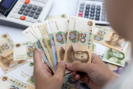 Woman holds Chinese Yuan banknotes in this illustration taken May 30, 2022. 