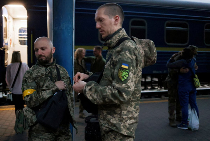 Territorial Defence members Oleksandr Zhygan, 37, and partner Antonina Romanova, 37, prepare to board a train to the frontline, as Russia's attack on Ukraine continues, at a train station in Kyiv, Ukraine May 25, 2022. Picture taken May 25, 2022.