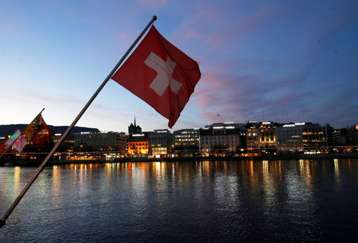 A Swiss flag is pictured during the sunrise on the Commercial and Financial District in Geneva, Switzerland, November 23, 2017. 