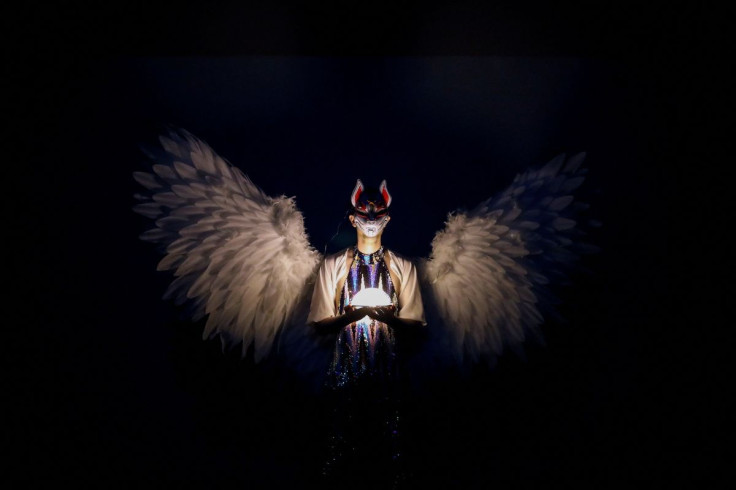 Queer novelist and artist Sam Albatros holds a light as they perform during "The Queer Archive Festival" in Athens, Greece, May 12, 2022.