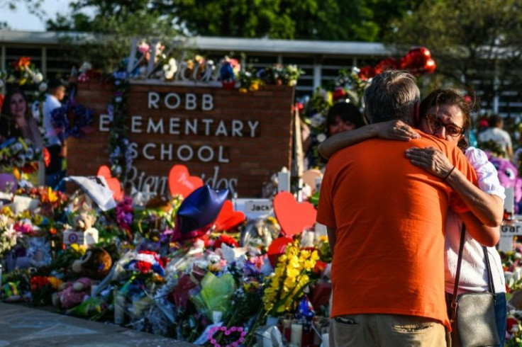 Mourners placed flowers at a makeshift memorial in front of the Robb Elementary School in Uvalde, Texas, where a gunman killed 19 children and two teachers