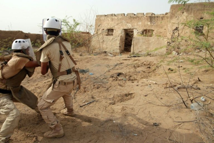 Members of Yemen's Saudi-backed pro-government forces search for explosive devices in a house in the village of Hays in western Hodeida province on May 23, 2022