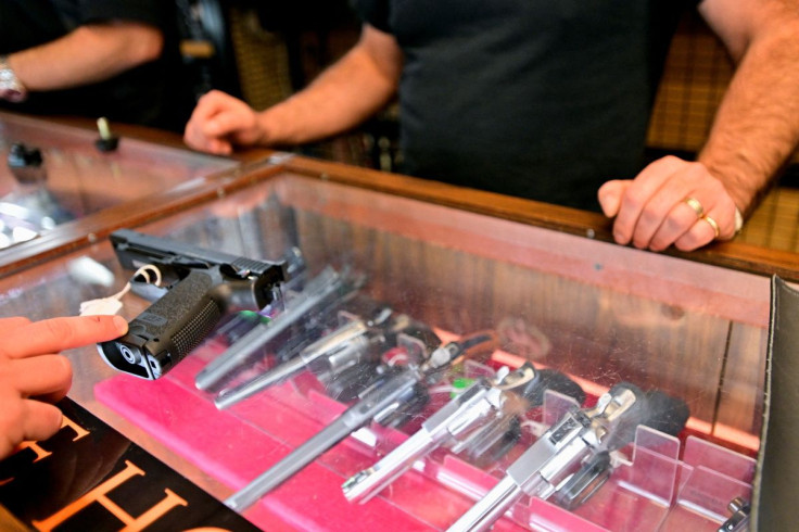 A customer at Wanstall's Hunting & Shooting looks at a handgun after Canada's government introduced legislation to implement a "national freeze" on the sale and purchase of handguns, as part of a gun control package that would also limit magazine capaciti