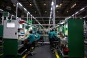 Employees work on the production line during an organised media tour to a Schneider Electric factory in Beijing, China February 17, 2022. 