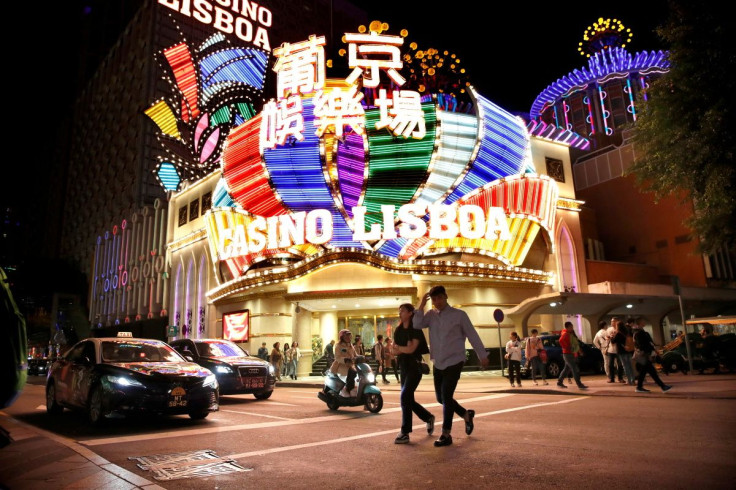 People walk in front of Casino Lisboa in Macau, China December 21, 2019.