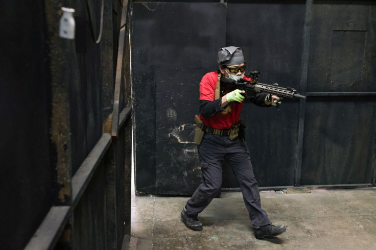 A trainee practices entering a building with his airsoft gun during an airsoft gun shooting lesson at the shooting range of the combat skill training company Polar Light, in New Taipei City, Taiwan, May 22, 2022. Since the war in Ukraine started three mon