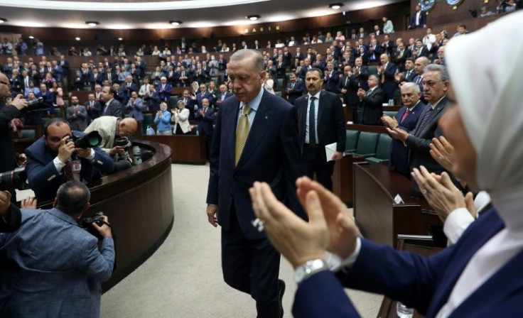 Turkish President Recep Tayyip Erdogan is applauded as he arrives to deliver a speech at the Turkish Grand National Assembly in Ankara on June 1