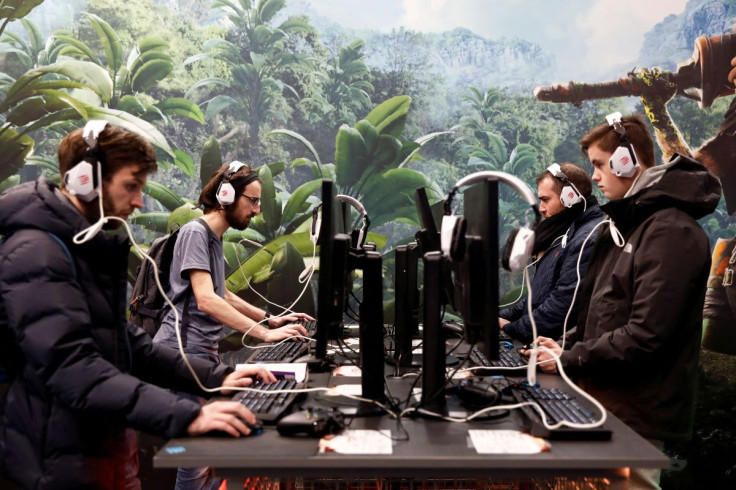 Attendees play video games at trade fair in Paris, France, October 29, 2019.