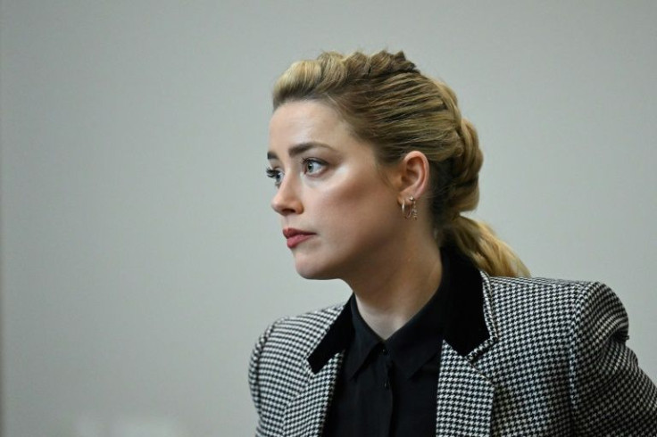 US actress Amber Heard attends the trial at the Fairfax County Circuit Courthouse in Fairfax, Virginia, on May 24, 2022.  Actor Johnny Depp is suing ex-wife Amber Heard for libel after she wrote an op-ed piece in The Washington Post in 2018 referring to h
