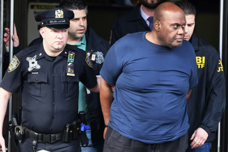 Suspect Frank James is escorted out of a police precinct after being arrested for a New York subway shooting