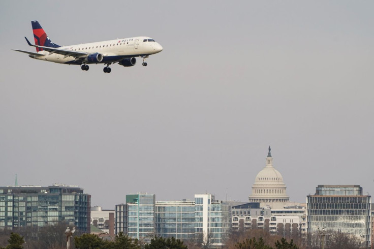A Delta Air Lines aircraft flies past the U.S. Capitol before landing at Reagan National Airport in Arlington, Virginia, U.S., January 24, 2022.   