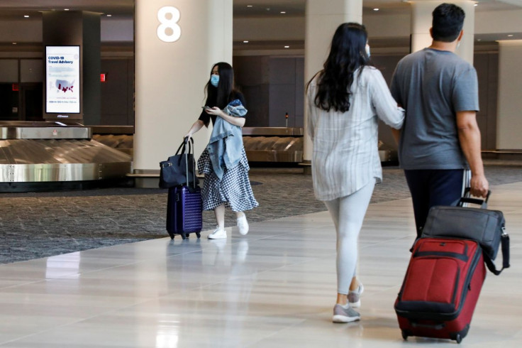 A sign alerts travelers to the danger of COVID-19 at LaGuardia Airport, during the outbreak of the coronavirus disease (COVID-19), in New York, U.S., June 29, 2020. 