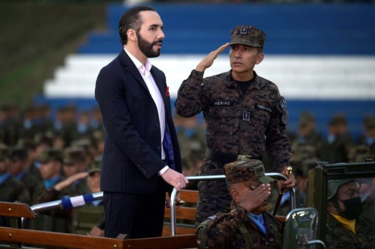 El Salvador President Nayib Bukele (L) and Defence Minister Rene Merino Monroy take part in a military graduation ceremony in San Salvador, in April 2022