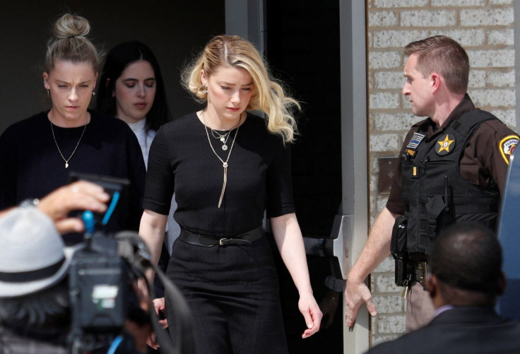 Amber Heard leaves Fairfax County Circuit Courthouse after the jury announced split verdicts in favor of both her ex-husband Johnny Depp and Heard on their claim and counter-claim in the Depp v. Heard civil defamation trial at the Fairfax County Circuit C