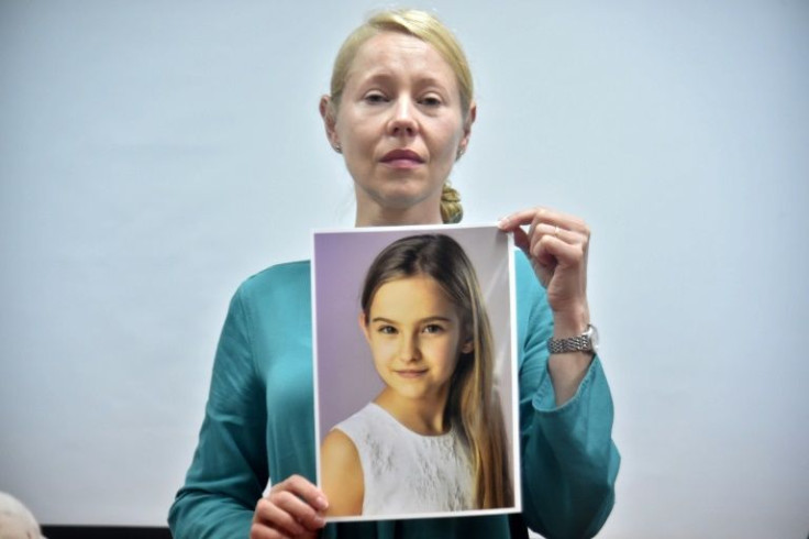 Anne Maja Reiniger-Egler with a picture of her missing daughter