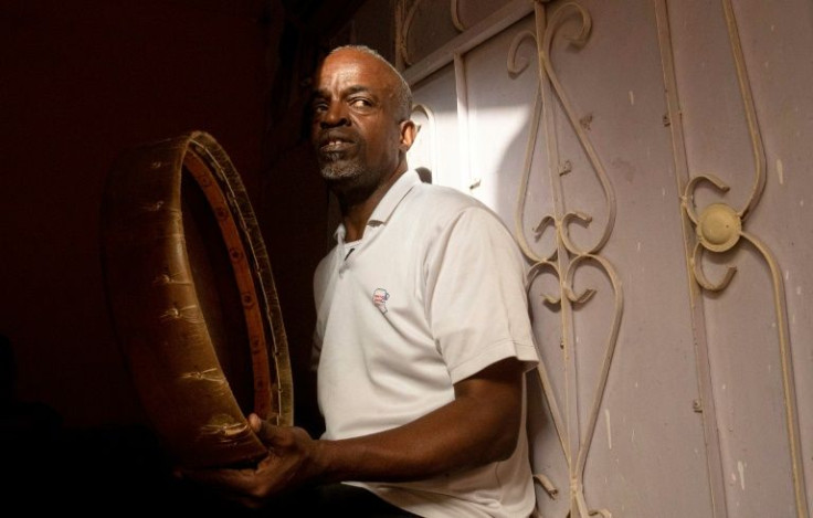 Adnane Abdelrahmane, 56, beats a hand drum at his home in Iraq's southern city of Zubair