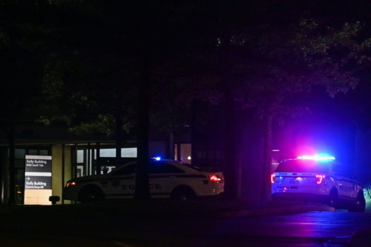Tulsa police cars block an entrance to the hospital where a gunman had earlier killed at least four people