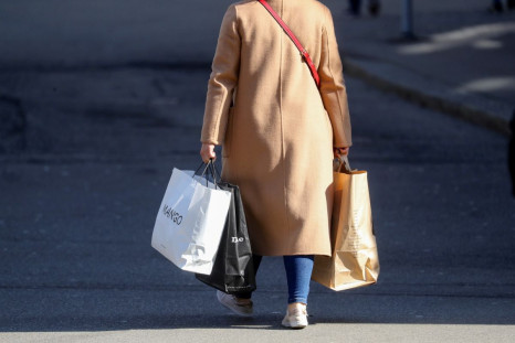 A shopper carries bags after the Swiss government relaxed some of its COVID-19 restrictions, as the spread of the coronavirus disease continues, at the Bahnhofstrasse shopping street in Zurich, Switzerland March 1,  2021. 